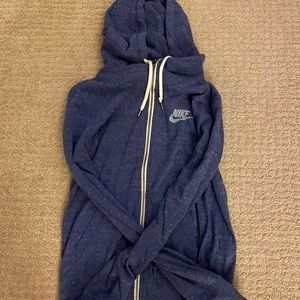Blue zip up Nike sweatshirt.
